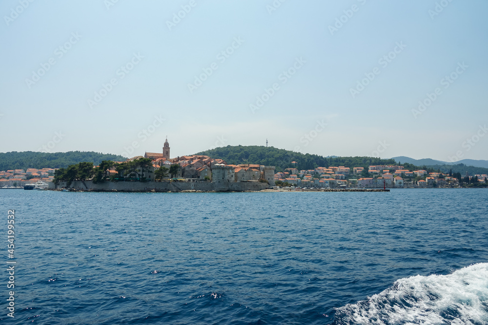 Croatia, Korcula view from seaside to odl town and small harbor.