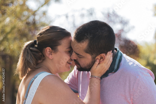  a fat couple about to kiss in a park