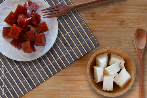 Guava candy and white cheese on wooden table - Brazilian desserts. Top view