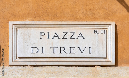 Fototapeta Naklejka Na Ścianę i Meble -  marble plate with Street name piazza di Trevi- engl: town square of Trevi -  at the wall in Rome