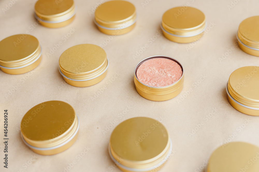 Eco friendly natural solid shampoo in metal cans on papaer background. Pattern. Concept animal fat free, zero waste, plastic free product Eco friendly natural solid shampoo in metal cans on papaer background. Pattern. Concept animal fat free, zero waste, plastic free product