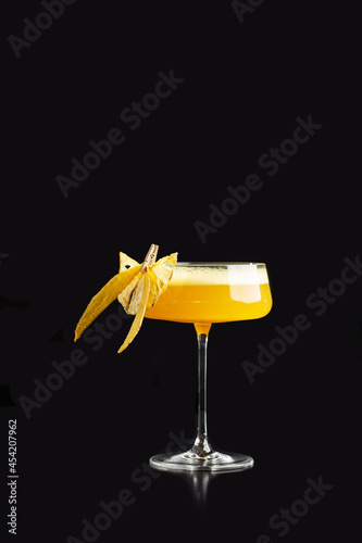 Summer Cocktail - Pornstar Martini. Drink with Passion fruit, Vodka, Liqueur, Vanilla Syrup, Champagne and Lime Juice. Black Background