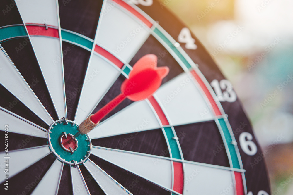 Business marketing success concept. Red dart arrow in center of the target dartboard. Bullseye is a target of business. Business marketing success concept. Red dart arrow in center of the target dartboard. Bullseye is a target of business.