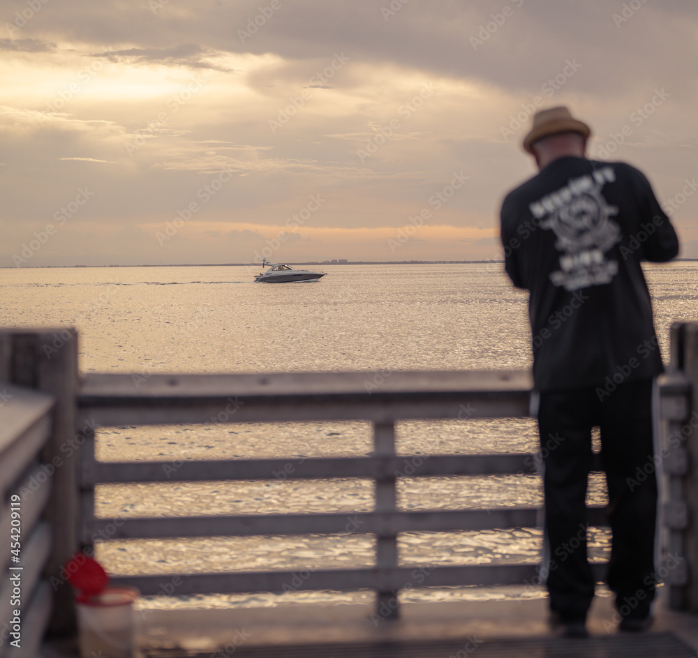 Fototapeta premium person on the pier horizon boat sea sky florida Key Biscayne man fishing hat 
