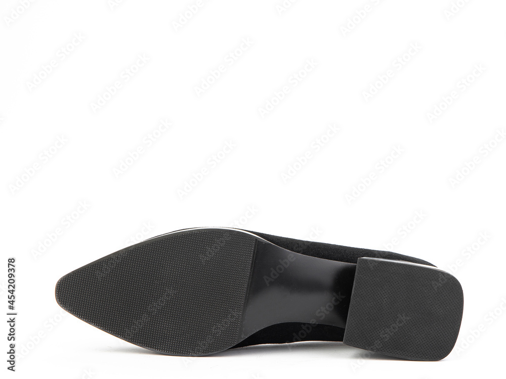 Classic and elegant suede high-heeled women shoes. Stylish black shoes on average heels and with a pointed toe. Isolated object close up on white background. Shoe sole view. Fashion shoes.