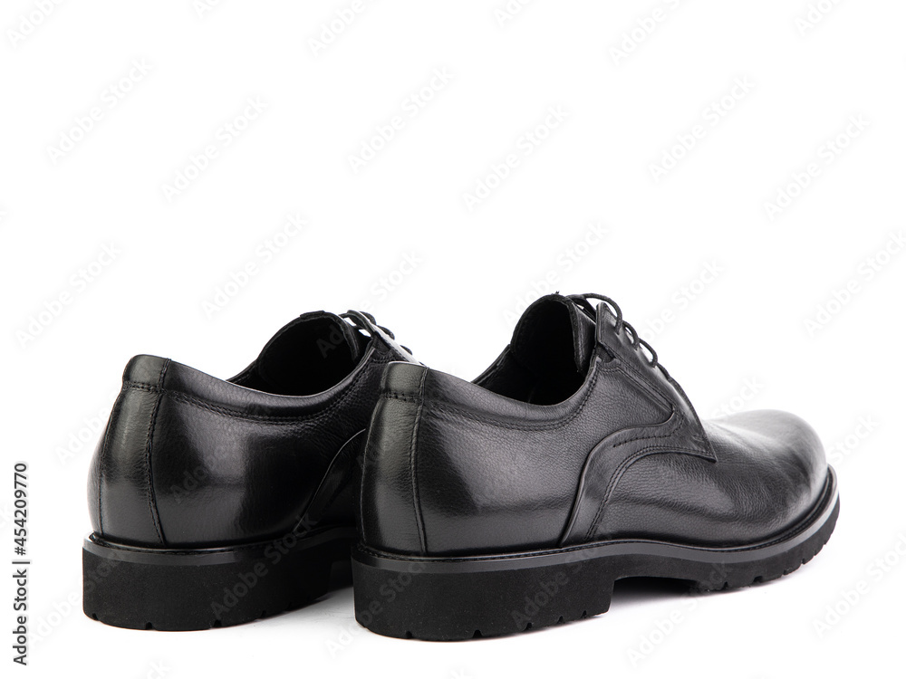 A pair of classic leather elegant men's shoes isolated white background. Groom's stylish black shoes. Isolated object close up on white background. Back side view. A pair of classic leather elegant men's shoes isolated white background. Groom's stylish black shoes. Isolated object close up on white background. Back side view.