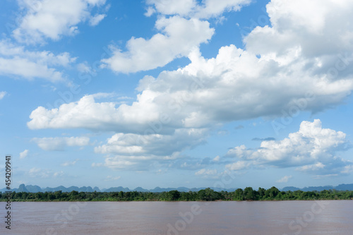River and cirrus, cumulus clouds on blue sky background..