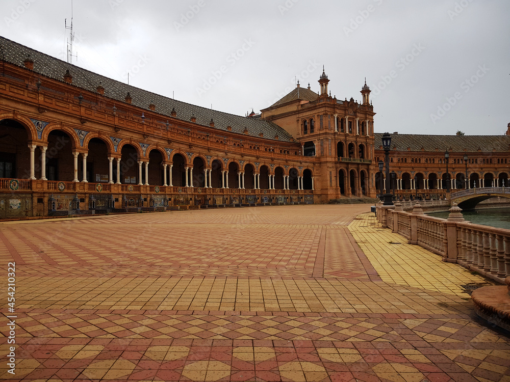 Panoramic view of a part of the Plaza de España in Seville. A touristic afternoon where you can appreciate the canal and one of the bridges, very colorful special flooring