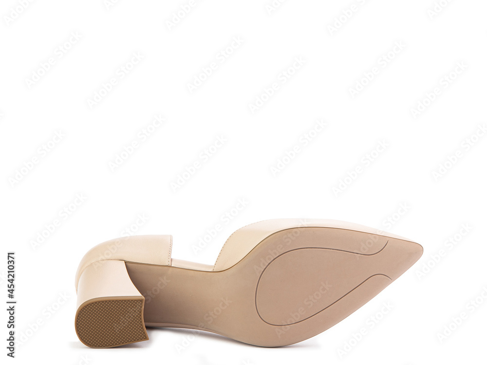 Classic and elegant suede high-heeled women shoes. Stylish beige shoes on high block heels and with a pointed toe. Isolated object close up on white background. Shoe sole view. Fashion shoes. Classic and elegant suede high-heeled women shoes. Stylish beige shoes on high block heels and with a pointed toe. Isolated object close up on white background. Shoe sole view. Fashion shoes.