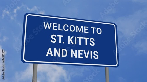 Welcome to St Kitts and Nevis Road Sign on Clear Blue Sky with Rapid Moving Clouds photo
