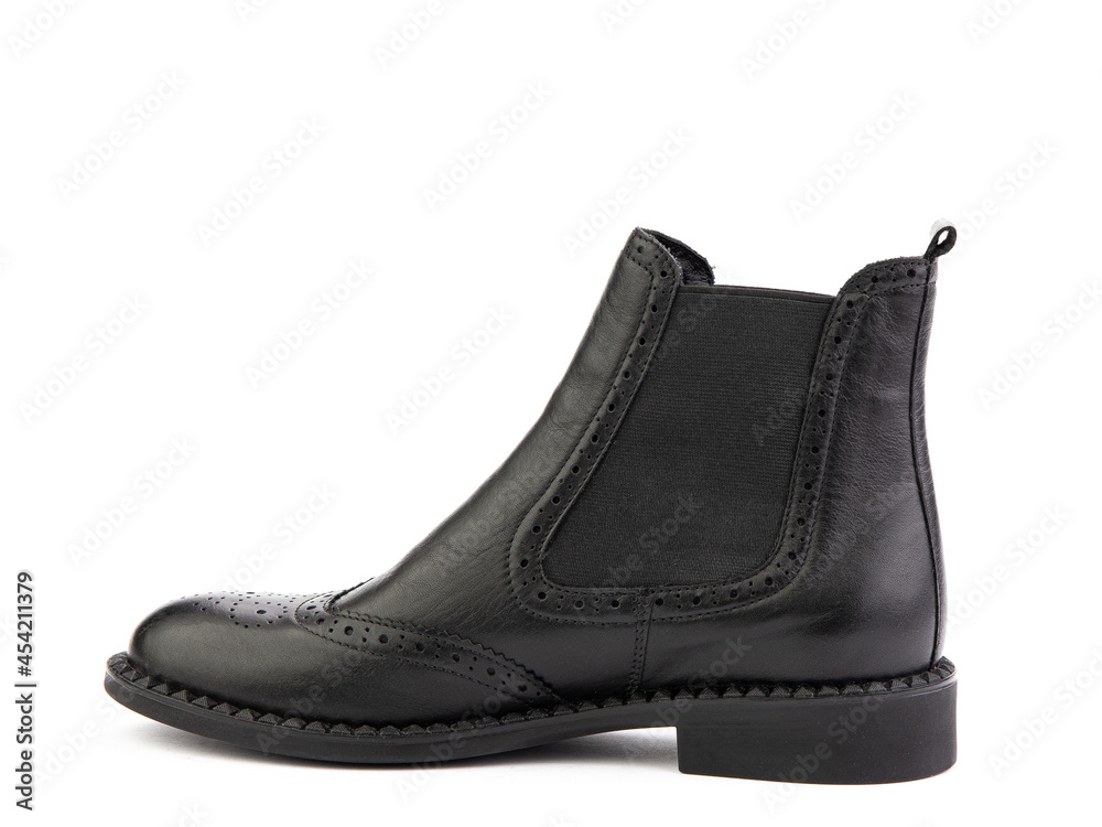 black leather chelsea boots with black elasticated side details, pattern details and black rubber sole. Isolated close-up on white background. Left side view. Fashion shoes. black leather chelsea boots with black elasticated side details, pattern details and black rubber sole. Isolated close-up on white background. Left side view. Fashion shoes.
