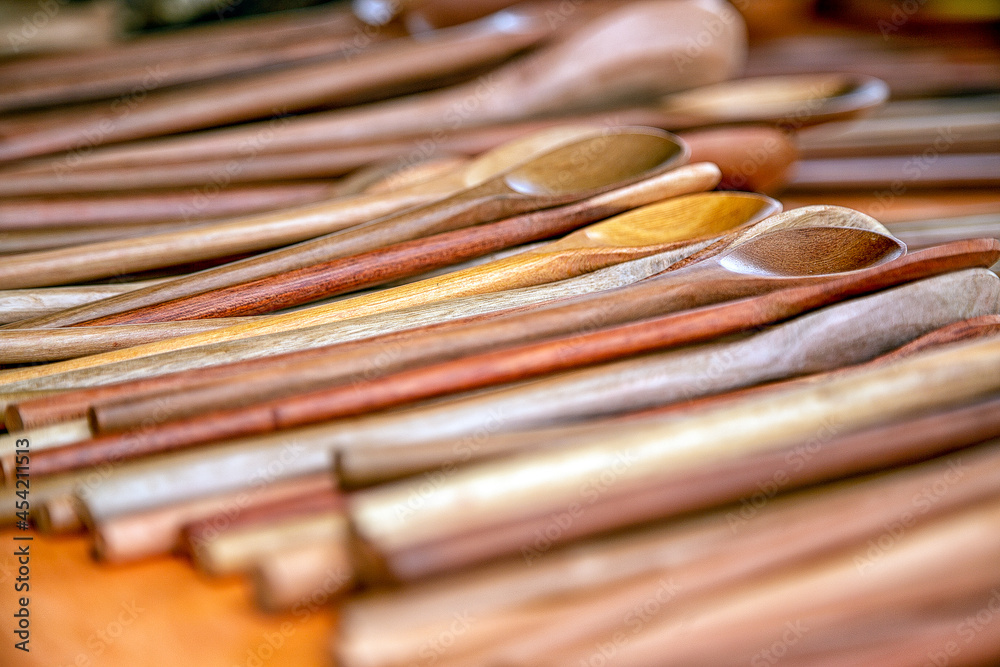 Wooden spoons at a fair. The wooden spoon was one of the objects used in the cooking of Brazilian indigenous peoples. Abstract. Background image. Wooden spoons at a fair. The wooden spoon was one of the objects used in the cooking of Brazilian indigenous peoples. Abstract. Background image.