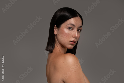 Beautiful swedish girl with natural freckles. Portrait of beauty young woman with nude shoulder.
