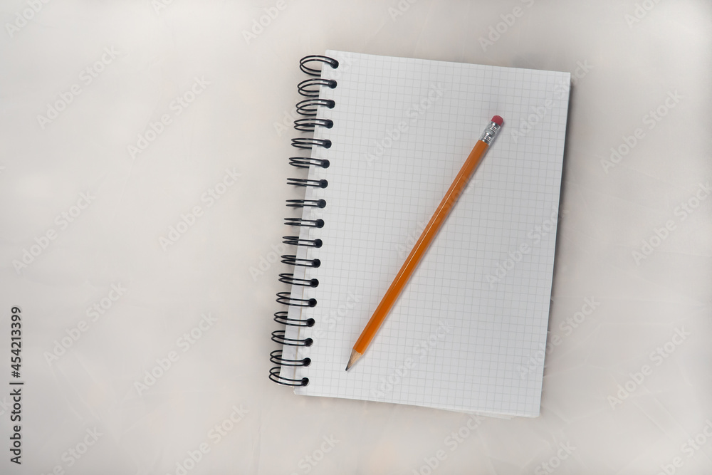 A PENCIL ON A NOTEBOOK A PENCIL ON A NOTEBOOK