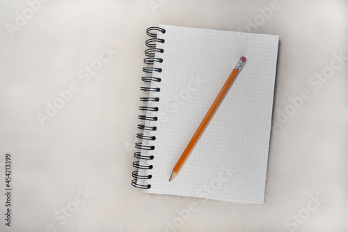 A PENCIL ON A NOTEBOOK