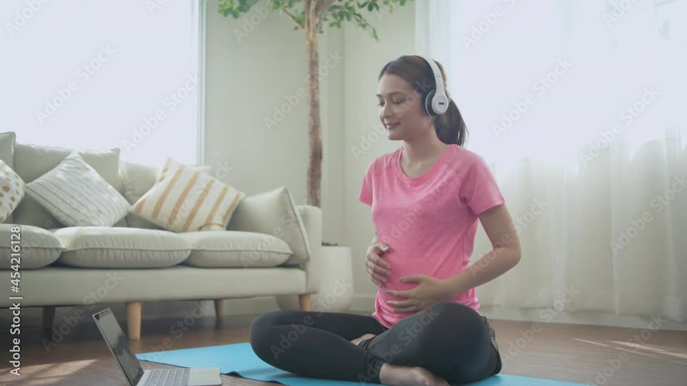 Pregnant woman concept of 4k Resolution. Asian girls practicing yoga using computer. Pregnant woman concept of 4k Resolution. Asian girls practicing yoga using computer.