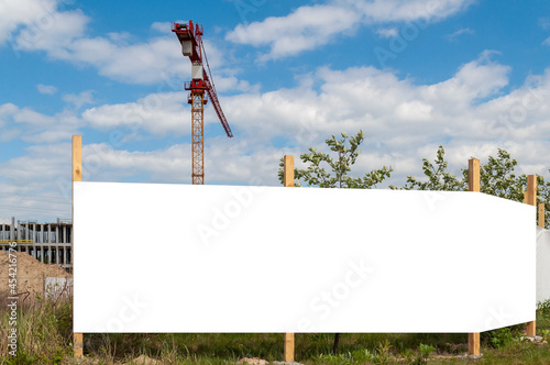 Blank white advertising banner on the construction cite fence