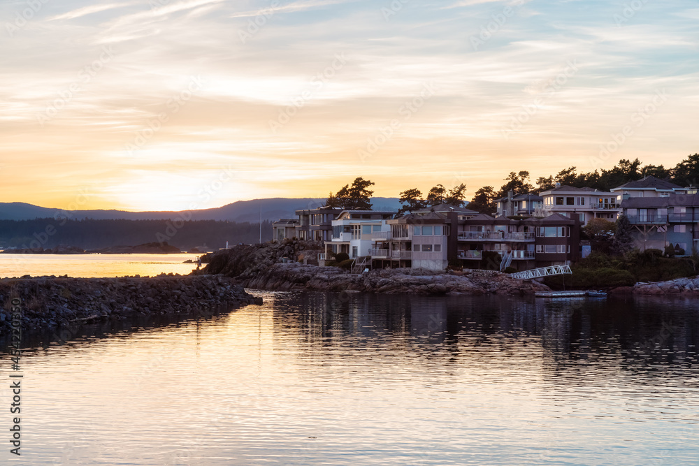 Scenic View of the residential homes on the West Pacific Ocean Coast. Summer Sunset. MacAulay Point Park in Victoria, Vancouver Island, British Columbia, Canada.