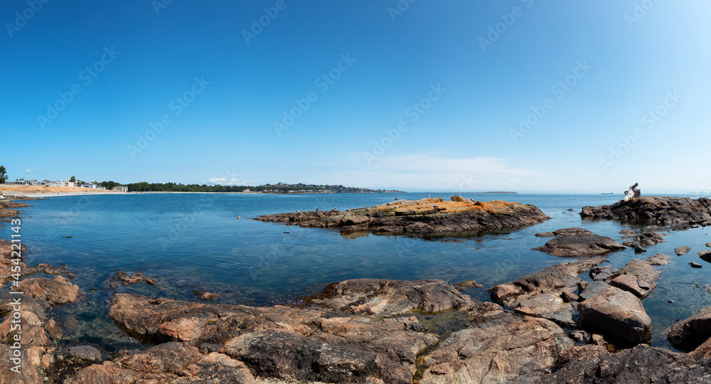 Panoramic View of Rocky shore with birds at a modern city park, Clover Point, during sunny summer day. Victoria, Vancouver Island, British Columbia, Canada.