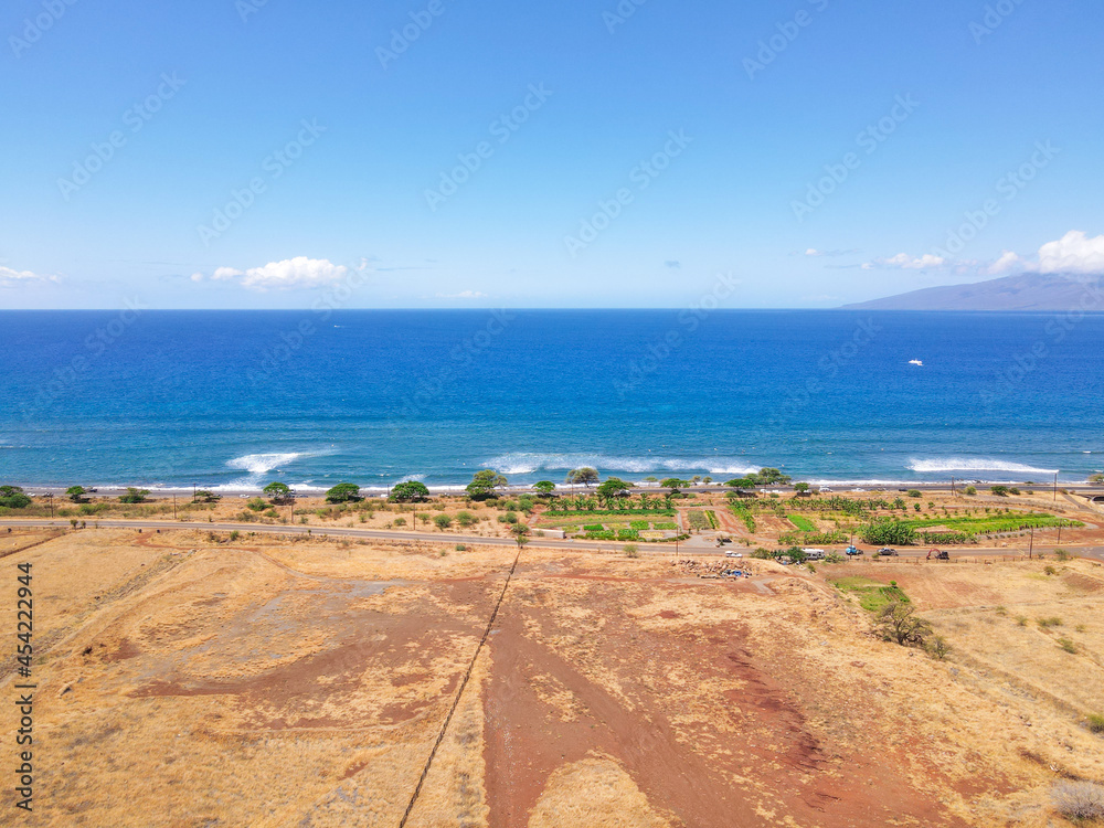 Aerial view of beach and ocean with waves in the island of Maui, Hawaii. Launiupoko State Beach during hot summer.