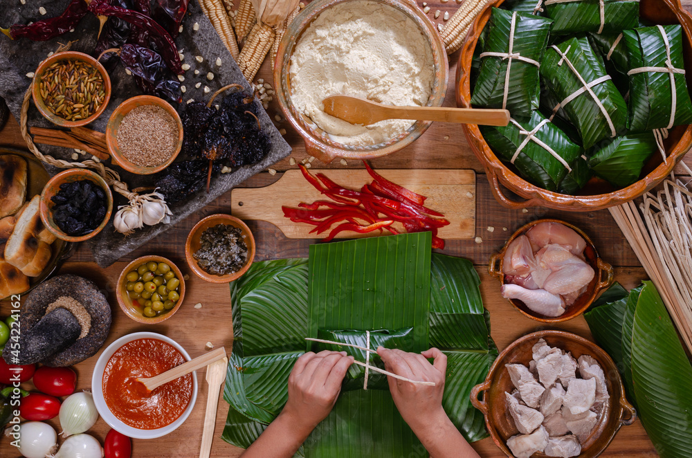 Hands making Guatemalan tamales.