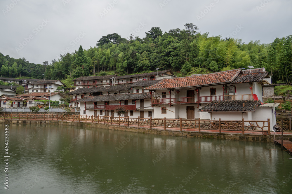 In the beautiful countryside, there is a small river flowing through and behind it are green mountains In the beautiful countryside, there is a small river flowing through and behind it are green mountains