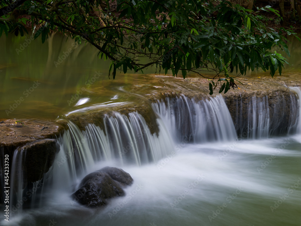 Fototapeta premium A small waterfall of a swaying stream.