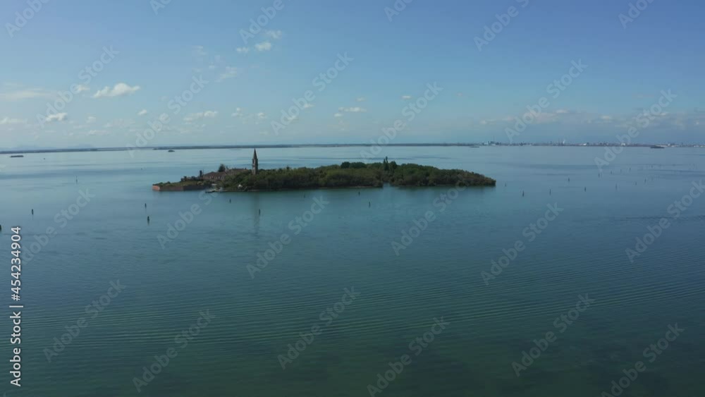 Aerial view of the plagued ghost island of Poveglia in the Venetian lagoon, opposite Malamocco along the Canal Orfano near Venice, Italy. Aerial view of the plagued ghost island of Poveglia in the Venetian lagoon, opposite Malamocco along the Canal Orfano near Venice, Italy.