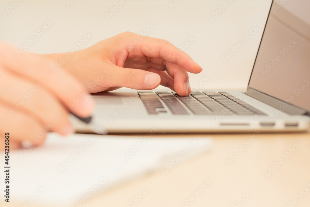 hand of freelancer working remotely on a laptop computer in tokyo, japan hand of freelancer working remotely on a laptop computer in tokyo, japan