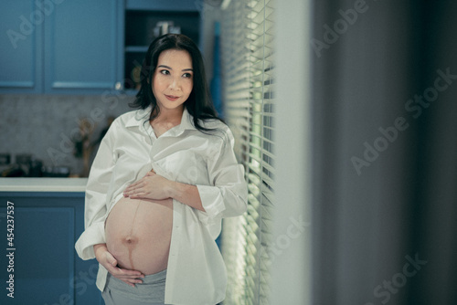 beautiful pregnant women, mother holding baby in pregnant belly 