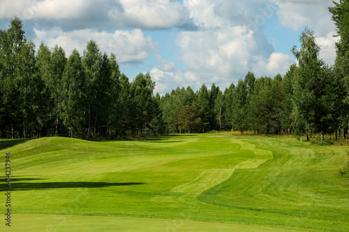 Panorama view of a Golf Course with fairway field. Golf course with a rich green turf beautiful scenery. High quality photo