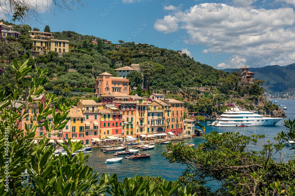 Panorama of Portofino seaside area with traditional colourful houses, harbour with numerous of yachts and ships, view from Castello Brown, Liguria, Italy