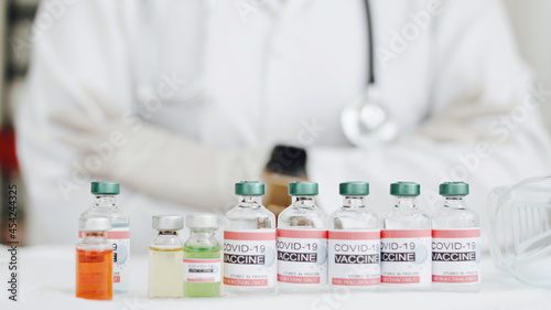 Coronavirus or COVID-19, 2019 - nCoV vaccine in a bottle with syringe,vaccine vial with physician supplies in background