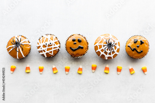 Top down view of a row of homemade cupcakes decorated for Halloween.