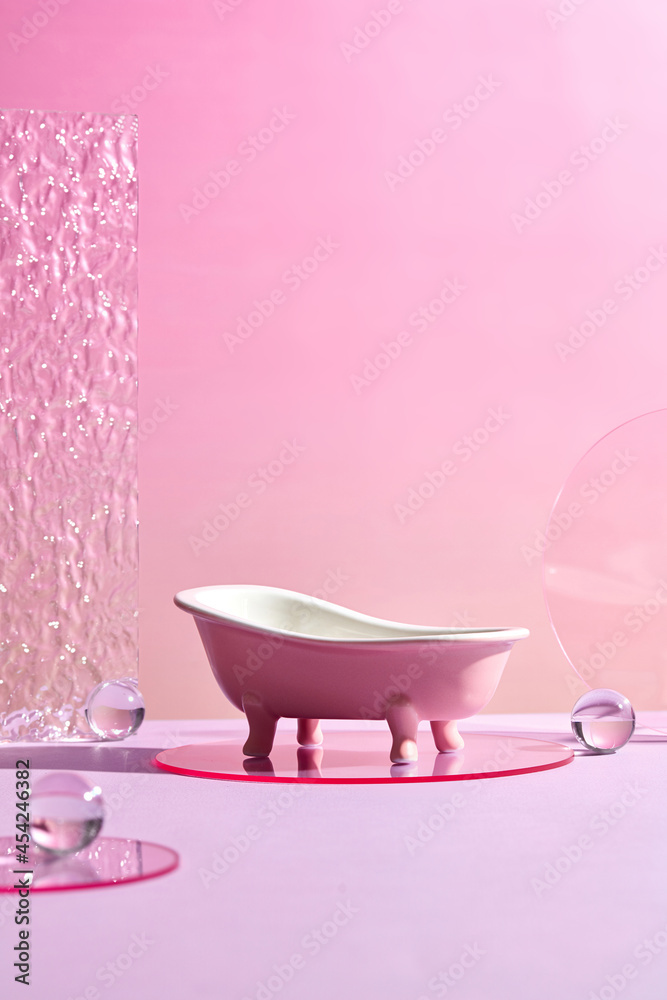 Bath tub mini with Glass Geometric podium and marbles . Monochrome platform with ribbed acrylic sheets and crystal podium on radiant pink background. Stylish background for presentation - obrazy, fototapety, plakaty 