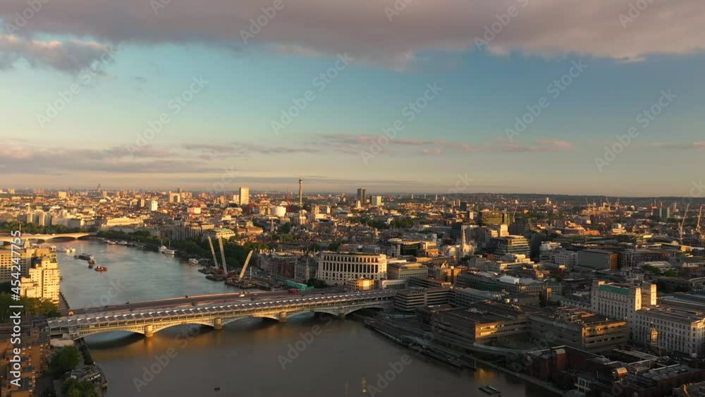 Thames river flowing through Blackfriars, lit by bright morning sun Thames river flowing through Blackfriars, lit by bright morning sun
