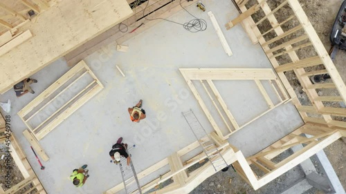 Wallpaper Mural Top ascending aerial view of the frame house under construction, process of installing the front wall with high crane Torontodigital.ca