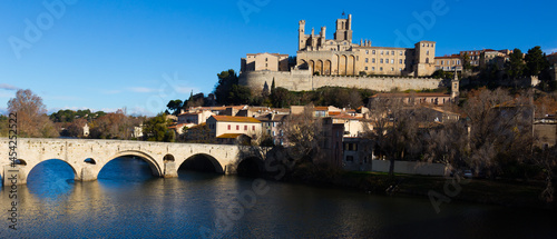 View of Cathedral of Saint Nazaire and Old Bridge across Orb river, Beziers, France photo