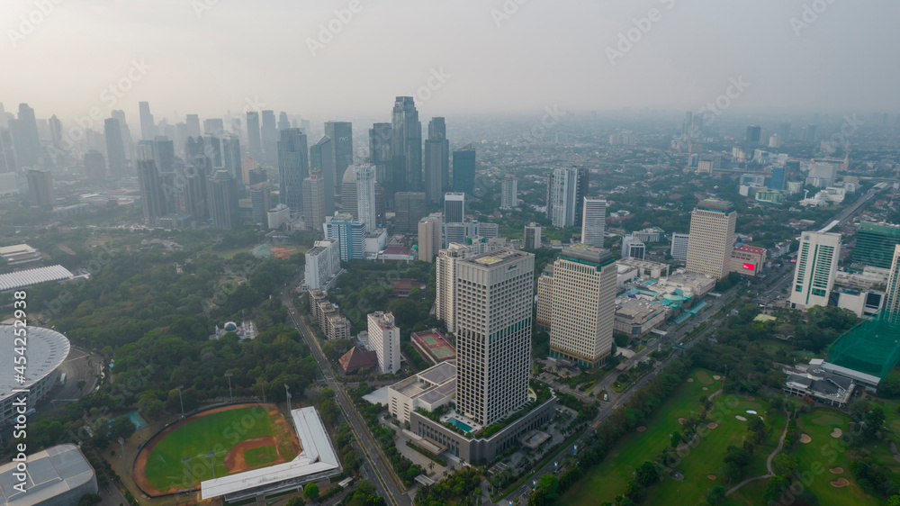 Fototapeta premium Aerial view of Asia Business concept for real estate - panoramic modern cityscape building bird eye aerial view under sunrise and morning blue bright sky in Jakarta. Indonesia