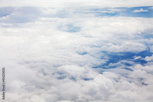 Fototapeta Naklejka Na Ścianę i Meble -  White clouds on blue sky background view from above, airplane flight landscape, beautiful aerial cloudscape, skies backdrop, fluffy cloud texture, sunny heaven, cloudy weather, cloudiness, copy space