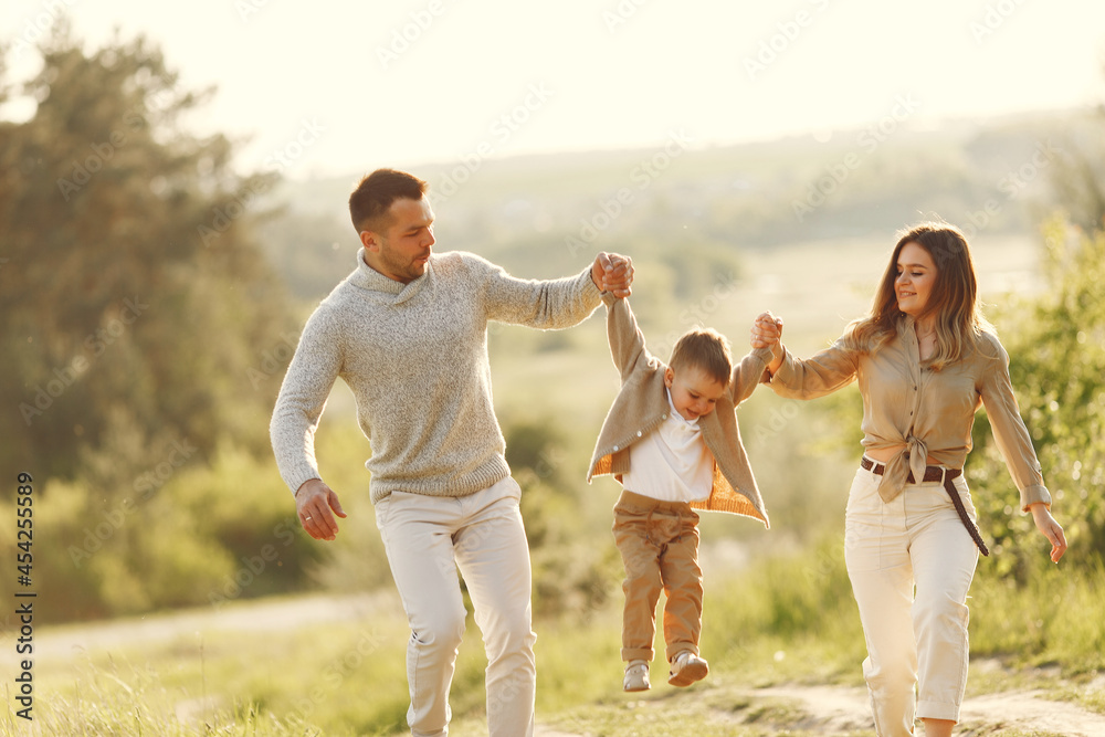 Fototapeta premium Cute family playing in a summer field
