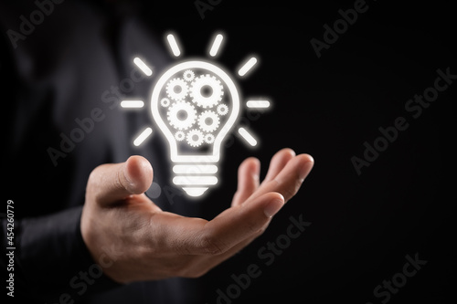Business idea bulb gear web engineering button icon in hand