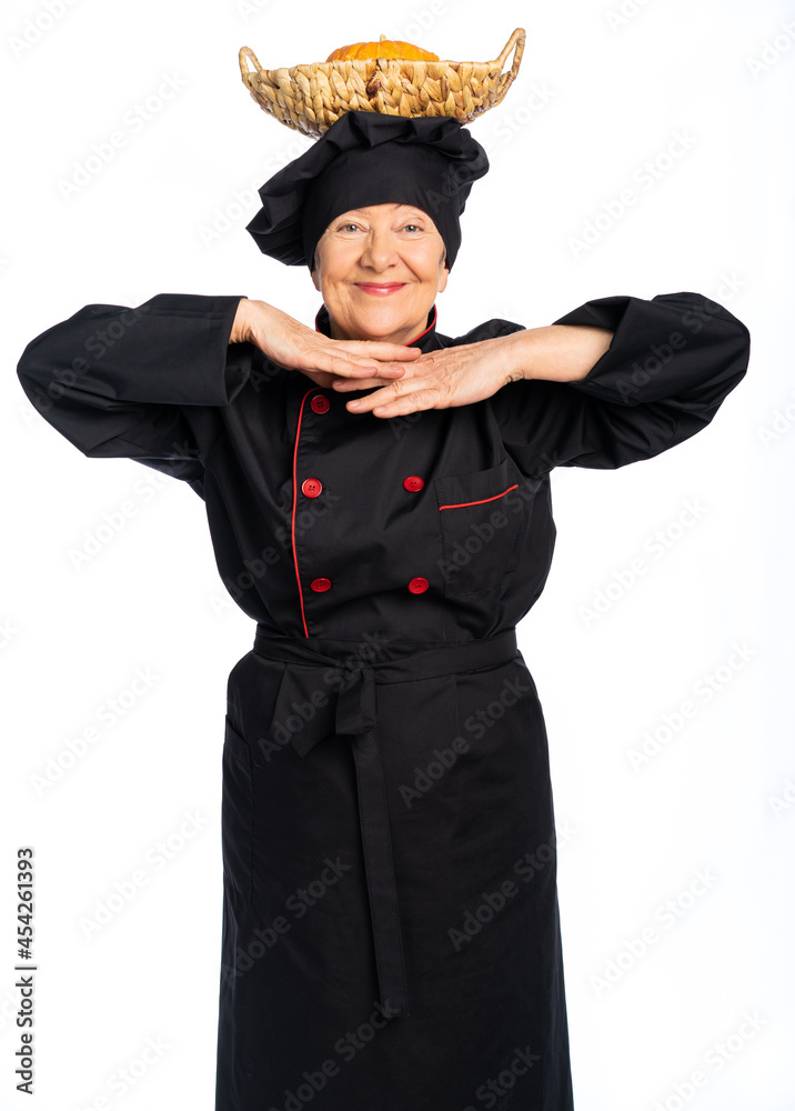a cook in black overalls holds kitchen utensils and looks at us. isolated white background a cook in black overalls holds kitchen utensils and looks at us. isolated white background