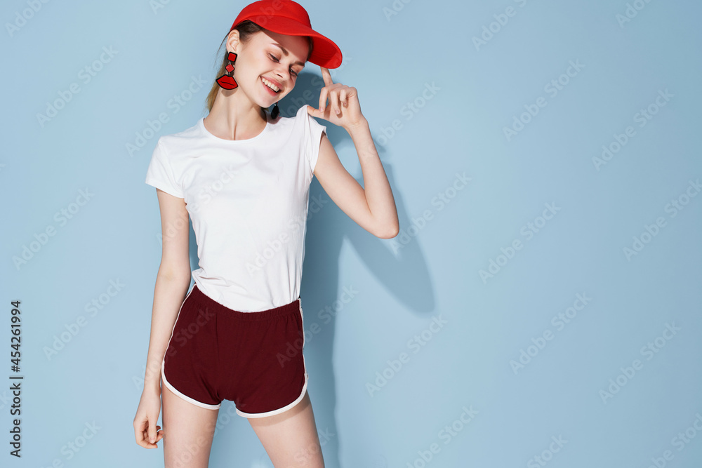 Obraz premium cheerful pretty woman in t-shirt and shorts summer clothes fashion blue background