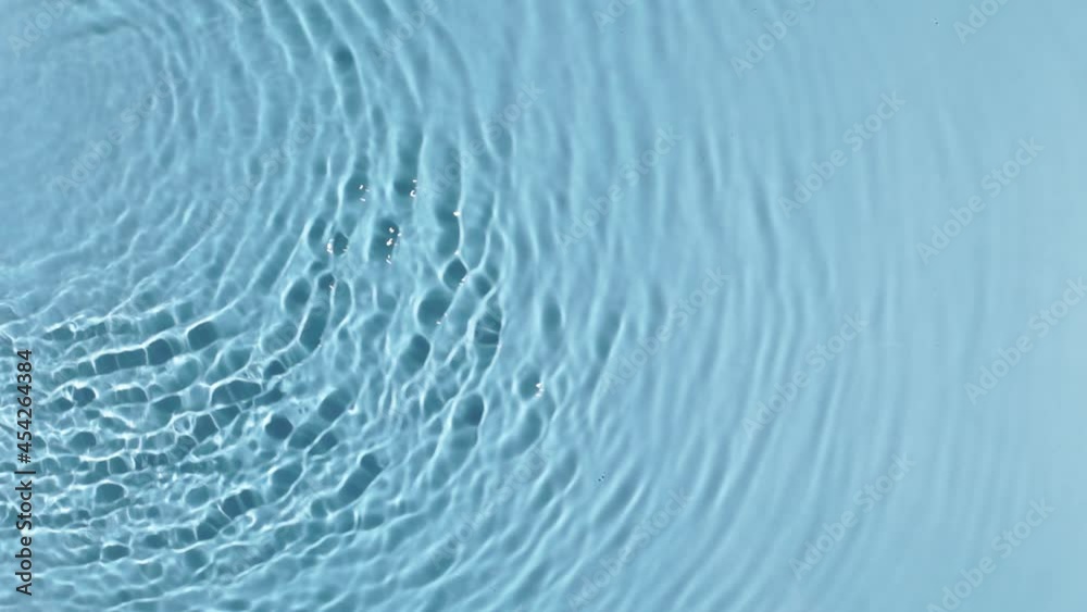 Water banner background. Blue aqua texture, surface of ripples, rings, transparen and sunlight. Spa concept background. Flat lay, top view, copy space Water banner background. Blue aqua texture, surface of ripples, rings, transparen and sunlight. Spa concept background. Flat lay, top view, copy space