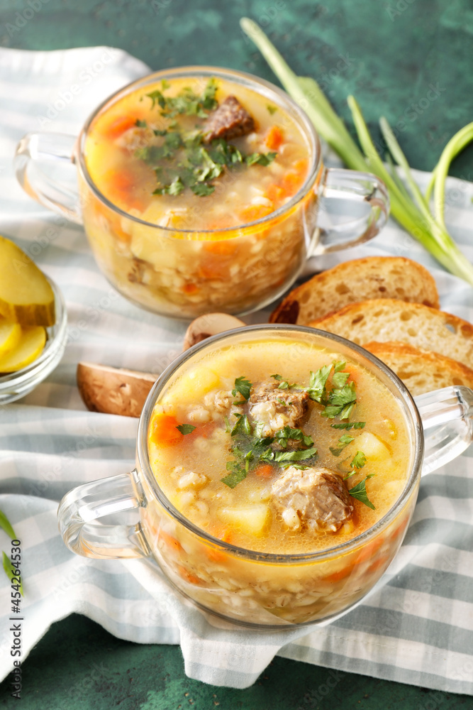 Bowls with tasty beef barley soup on color background Bowls with tasty beef barley soup on color background
