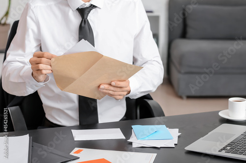 Young man with letter in of...