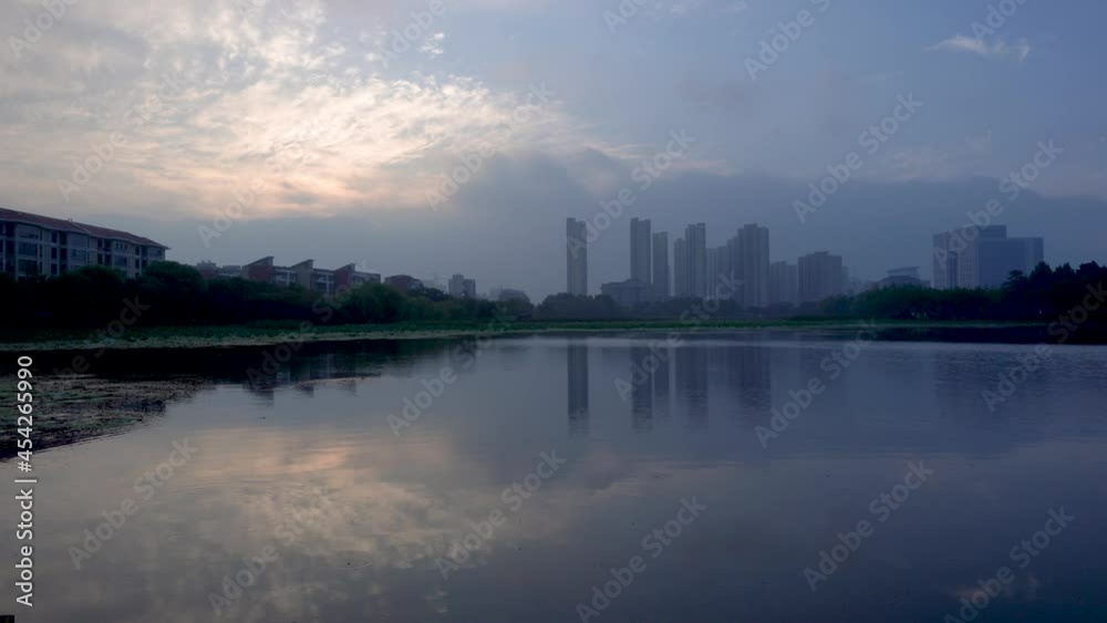 Sky clouds reflect in lakes in Huantan Park in Huaibei, Anhui Province, China. Sky clouds reflect in lakes in Huantan Park in Huaibei, Anhui Province, China.