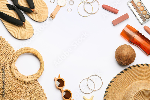 Frame made of beach accessories and cosmetics on white background, closeup
