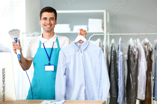 Male worker with steamer an...